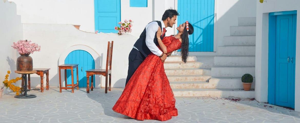 Bride and groom sharing a romantic moment in a Santorini-style courtyard.