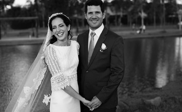 Destination wedding planner Europe 16 Happy bride and groom smiling by the riverside on their wedding day.